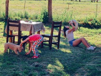 Woman with arms raised on field