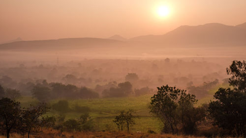 Scenic view of landscape against sky during sunset