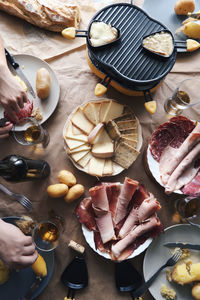 High angle view of ham and cheese in plates on table