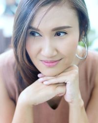 Close-up portrait of smiling young woman