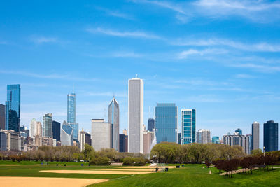 View of skyscrapers against cloudy sky