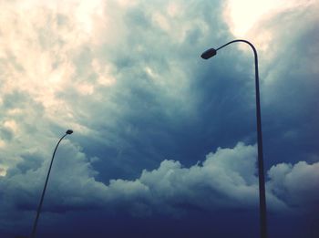 Low angle view of street light against cloudy sky
