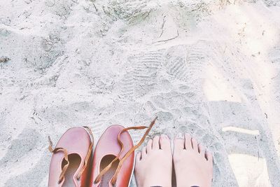 Low section of person on beach against sky