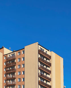 Low angle view of buildings against clear blue sky