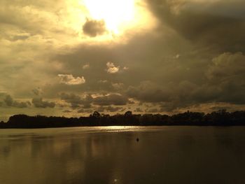 Scenic view of sea against cloudy sky at sunset