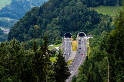 High angle view of cars moving on road against trees