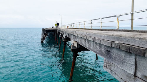 Bridge over sea against sky