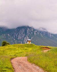 Scenic view of landscape against cloudy sky