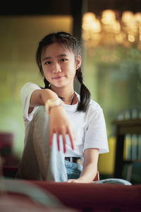 Portrait of teenage girl sitting outdoors