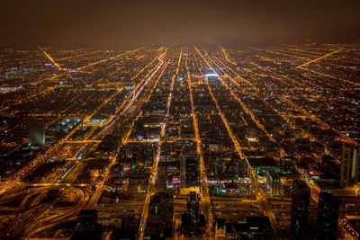 Aerial view of city lit up at night