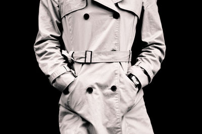 Close-up of man standing against black background