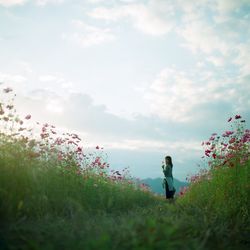 Side view of a woman standing on landscape