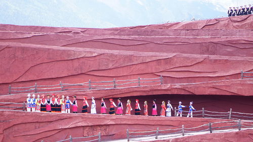 People wearing traditional clothing walking on mountain road