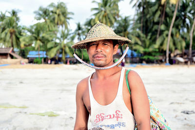 Portrait of man wearing hat on beach