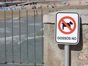 Close-up of information sign at beach