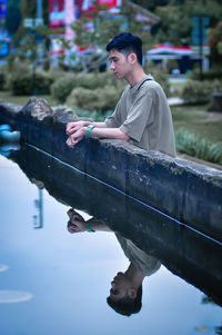 Side view of young man sitting in boat