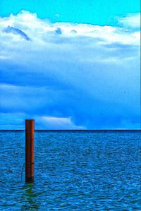 Scenic view of sea against blue sky