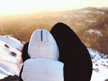 Close-up of man against sky at sunset