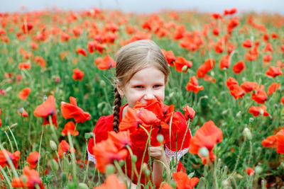 Portrait of girl with red poppy flowers