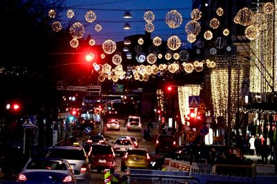 Cars on city street at night