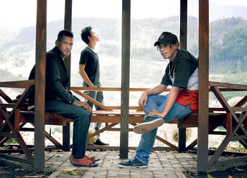 Young men sitting on table