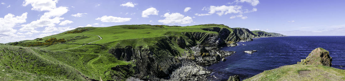 Panoramic view of green mountains against sky