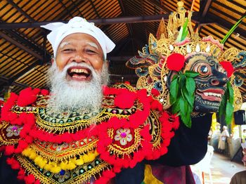 Portrait of smiling man wearing costume during traditional festival