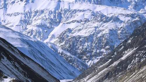 Aerial view of snowcapped mountains against sky