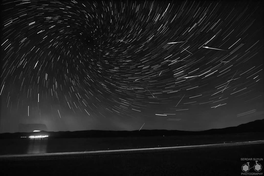 motion, night, scenics, water, star trail, beauty in nature, tranquil scene, tranquility, long exposure, nature, sky, illuminated, majestic, astronomy, outdoors, star field, non-urban scene, exploding, sea, bright