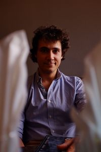 Portrait of man sitting at table in restaurant