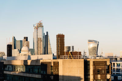 Modern buildings in city against clear sky