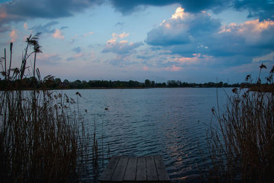 Scenic view of lake against sky at sunset