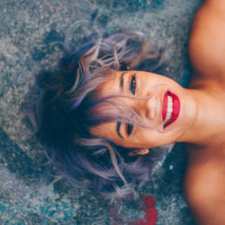 Portrait of smiling woman lying down