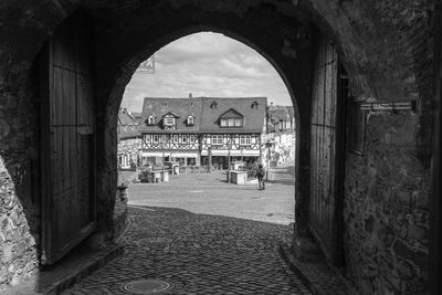 Archway in city against sky