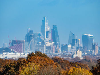 View of modern buildings against clear blue sky