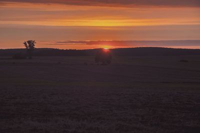 Scenic view of field against sky during sunset