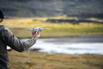 Man holds drone and ready to fly