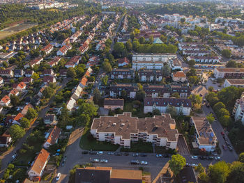 High angle view of trees and buildings in city