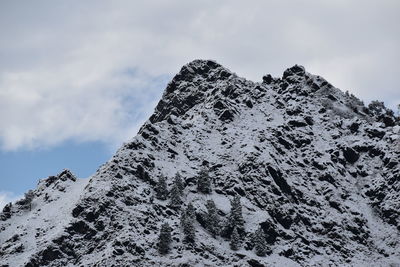 Low angle view of snowcapped mountain against sky