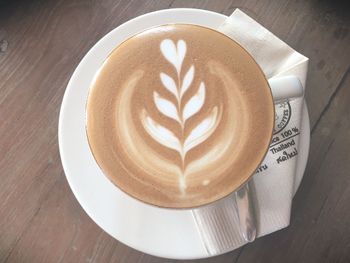 Directly above shot of cappuccino served on table