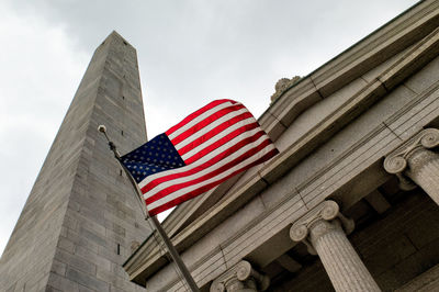 Low angle view of flag on building against sky