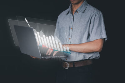 Midsection of man using mobile phone