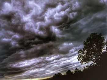 Silhouette of tree against cloudy sky