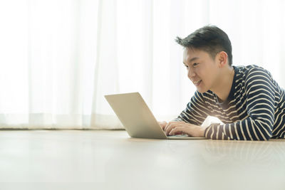 Young man looking at camera on table