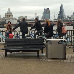 Rear view of people looking at city