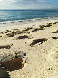 Close-up of sand on beach against sky