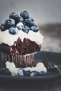 Close-up of cupcake with blueberries served in plate