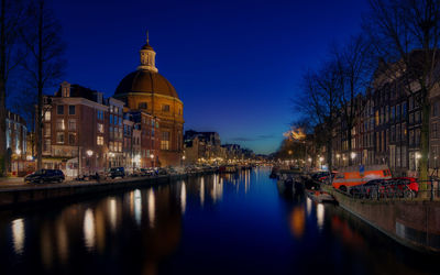 Reflection of illuminated buildings in canal at night