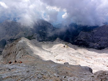 Scenic view of mountains against cloudy sky