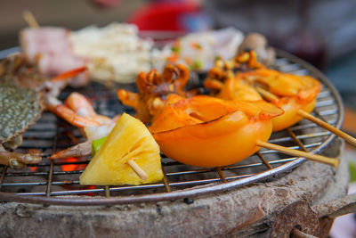 Close-up of orange fruit on barbecue grill